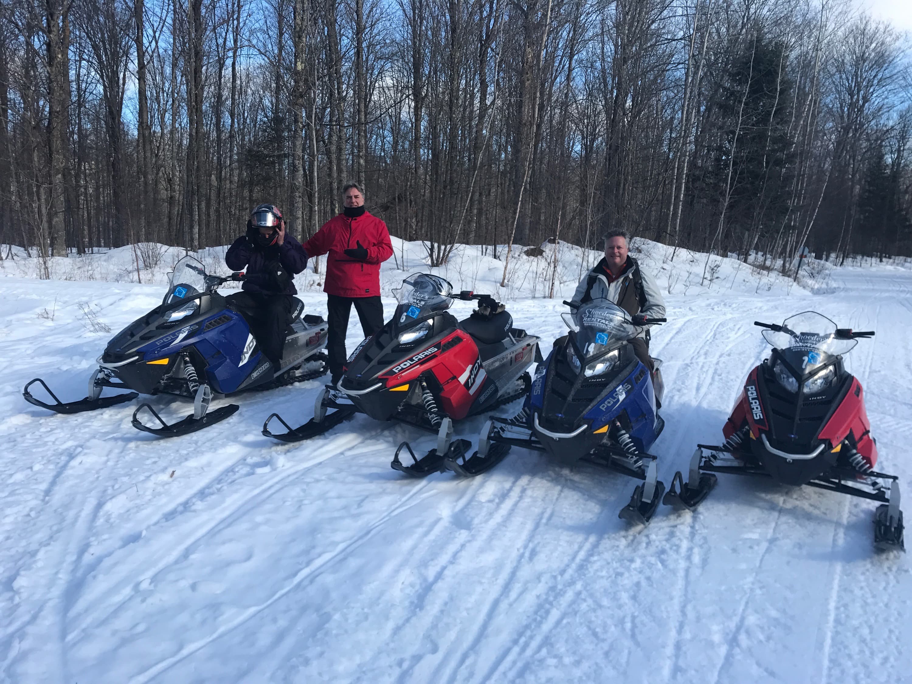 Group snowmobiling on groomed trail